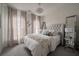 Inviting bedroom with a tufted headboard, plush bedding, neutral color palette, and decorative lighting at 1049 Brandsford Nw St # 27-01, Atlanta, GA 30318