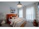 Stylish bedroom with a striking orange bed frame, modern decor, and plenty of natural light at 1049 Brandsford Nw St # 27-01, Atlanta, GA 30318