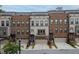 Charming brick and siding townhome featuring a private entrance, and a neutral garage door at 1049 Brandsford Nw St # 27-01, Atlanta, GA 30318