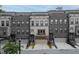 Charming brick and siding townhome featuring a private entrance, and a neutral garage door at 1049 Brandsford Nw St # 27-01, Atlanta, GA 30318