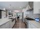 Modern kitchen featuring stainless steel appliances, stone backsplash, and a large island at 1049 Brandsford Nw St # 27-01, Atlanta, GA 30318