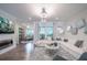 Inviting living room with modern fireplace, plush sofa, and seamless access to the outdoor balcony at 1049 Brandsford Nw St # 27-01, Atlanta, GA 30318