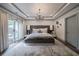 Main bedroom with decorative ceiling, modern decor, hardwood floors and patio access at 1049 Brandsford Nw St # 27-01, Atlanta, GA 30318