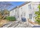 Backyard with concrete patio and house exterior with white siding and shutters at 1510 Ridgemill Ter, Dacula, GA 30019