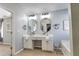 Bathroom featuring double vanity sinks, granite countertops, and large mirrors at 1510 Ridgemill Ter, Dacula, GA 30019