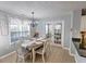 Cozy dining area bathed in natural light, featuring a chandelier and views to another room at 1510 Ridgemill Ter, Dacula, GA 30019