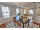 Dining room featuring hardwood floors, a modern chandelier, and large windows at 1510 Ridgemill Ter, Dacula, GA 30019