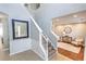 Grand foyer featuring a staircase, stylish mirror, and views into the living room at 1510 Ridgemill Ter, Dacula, GA 30019