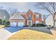 Attractive two-story brick home featuring a two-car garage, landscaped yard, and welcoming entrance at 1510 Ridgemill Ter, Dacula, GA 30019