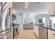 Open kitchen featuring stainless steel appliances, granite countertops, and a seamless view into the living room at 1510 Ridgemill Ter, Dacula, GA 30019