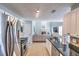 Kitchen with stainless steel appliances, granite countertops and view into the living room with fireplace at 1510 Ridgemill Ter, Dacula, GA 30019