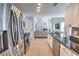 Open kitchen featuring granite countertops and stainless steel appliances overlooking the living room at 1510 Ridgemill Ter, Dacula, GA 30019