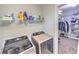 Functional laundry room with modern washer and dryer units and storage at 1510 Ridgemill Ter, Dacula, GA 30019