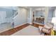 Open-concept living room with hardwood floors, staircase and views into the dining area at 1510 Ridgemill Ter, Dacula, GA 30019