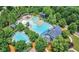 Aerial view of community pool with multiple pools, a slide, and surrounding trees at 316 Willow Cv, Canton, GA 30114