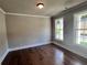 Cozy bedroom featuring hardwood floors, neutral paint, white trim and two windows with natural light at 316 Willow Cv, Canton, GA 30114