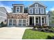 Charming two-story home with stone accents, a two-car garage, and a well-manicured lawn at 316 Willow Cv, Canton, GA 30114