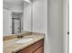 Bathroom featuring granite countertop and shower with black trim and sliding glass doors at 681 Deer Springs Way, Loganville, GA 30052