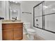 Cozy bathroom with granite countertops, a wood vanity, and a glass-enclosed shower at 681 Deer Springs Way, Loganville, GA 30052