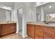 Bathroom featuring double vanity with granite countertops and warm wood cabinets at 681 Deer Springs Way, Loganville, GA 30052