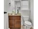 Chic half-bathroom features a granite countertop, dark wood cabinet, toilet, and decorative accessories at 681 Deer Springs Way, Loganville, GA 30052