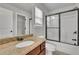 Bathroom featuring granite countertop and shower with black trim and sliding glass doors at 681 Deer Springs Way, Loganville, GA 30052