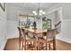 Well-lit dining room with hardwood floors, wainscoting, stylish chandelier, and a wooden dining table at 681 Deer Springs Way, Loganville, GA 30052