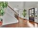 Elegant foyer featuring hardwood floors, a staircase with iron railings, and bright natural light at 681 Deer Springs Way, Loganville, GA 30052