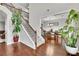 Spacious foyer showcasing a staircase with iron railings, hardwood floors, and an open dining area at 681 Deer Springs Way, Loganville, GA 30052