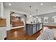 Modern kitchen with gray island, granite countertops, and open layout to the living room at 681 Deer Springs Way, Loganville, GA 30052