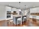 Spacious kitchen with white cabinetry, stainless steel appliances, and a kitchen island with barstool seating at 681 Deer Springs Way, Loganville, GA 30052