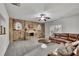 Cozy living room features a stone fireplace, plush carpet, recessed lighting, and comfortable leather seating at 681 Deer Springs Way, Loganville, GA 30052