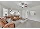 Open-concept living room featuring a comfortable leather sofa and a view into the modern kitchen at 681 Deer Springs Way, Loganville, GA 30052