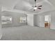 Large main bedroom featuring a tray ceiling, carpet, and two windows at 681 Deer Springs Way, Loganville, GA 30052