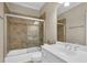 Ensuite bathroom with a tiled shower, white vanity, and stylish fixtures at 7467 Portbury Park Ln, Suwanee, GA 30024