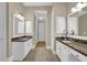 Spacious bathroom showcasing dual vanities with granite countertops and modern fixtures at 7467 Portbury Park Ln, Suwanee, GA 30024