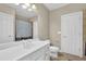 Well-lit bathroom featuring a double vanity, soaking tub, and glass-enclosed shower at 7467 Portbury Park Ln, Suwanee, GA 30024