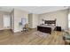 Spacious bedroom featuring wood floors, a desk, and bright natural light from large windows at 7467 Portbury Park Ln, Suwanee, GA 30024