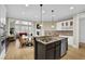 Bright kitchen with granite countertops, stainless steel appliances, and connected breakfast nook at 7467 Portbury Park Ln, Suwanee, GA 30024