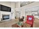 Elegant living room with fireplace, built-ins, and view into adjacent kitchen space at 7467 Portbury Park Ln, Suwanee, GA 30024