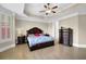 Main bedroom suite features a tray ceiling, light-filled windows, and ensuite bathroom at 7467 Portbury Park Ln, Suwanee, GA 30024