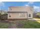 View of the back exterior with ample green space and a fenced yard under a sunny sky at 142 Parkside Dr, Stockbridge, GA 30281