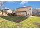 Large backyard featuring green grass, a patio, and a wood fence under a clear sky at 142 Parkside Dr, Stockbridge, GA 30281