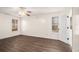 Bright bedroom with dark wood flooring, ceiling fan, and natural light at 142 Parkside Dr, Stockbridge, GA 30281