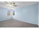 Comfortable bedroom with neutral carpeting, two windows, and a ceiling fan at 142 Parkside Dr, Stockbridge, GA 30281