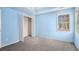 Comfortable bedroom with large closet, neutral carpeting and tray ceiling at 142 Parkside Dr, Stockbridge, GA 30281