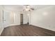Spacious bedroom with two closets and ensuite bathroom featuring wood-look floors and a ceiling fan at 142 Parkside Dr, Stockbridge, GA 30281