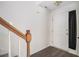Welcoming entryway featuring hardwood floors and staircase with wooden handrail at 142 Parkside Dr, Stockbridge, GA 30281