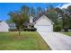 Charming single-Gathering home with well-maintained lawn and two-car garage in a suburban neighborhood at 142 Parkside Dr, Stockbridge, GA 30281