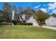 Inviting one-story home with a manicured front yard, a chimney, and an attached two-car garage at 142 Parkside Dr, Stockbridge, GA 30281